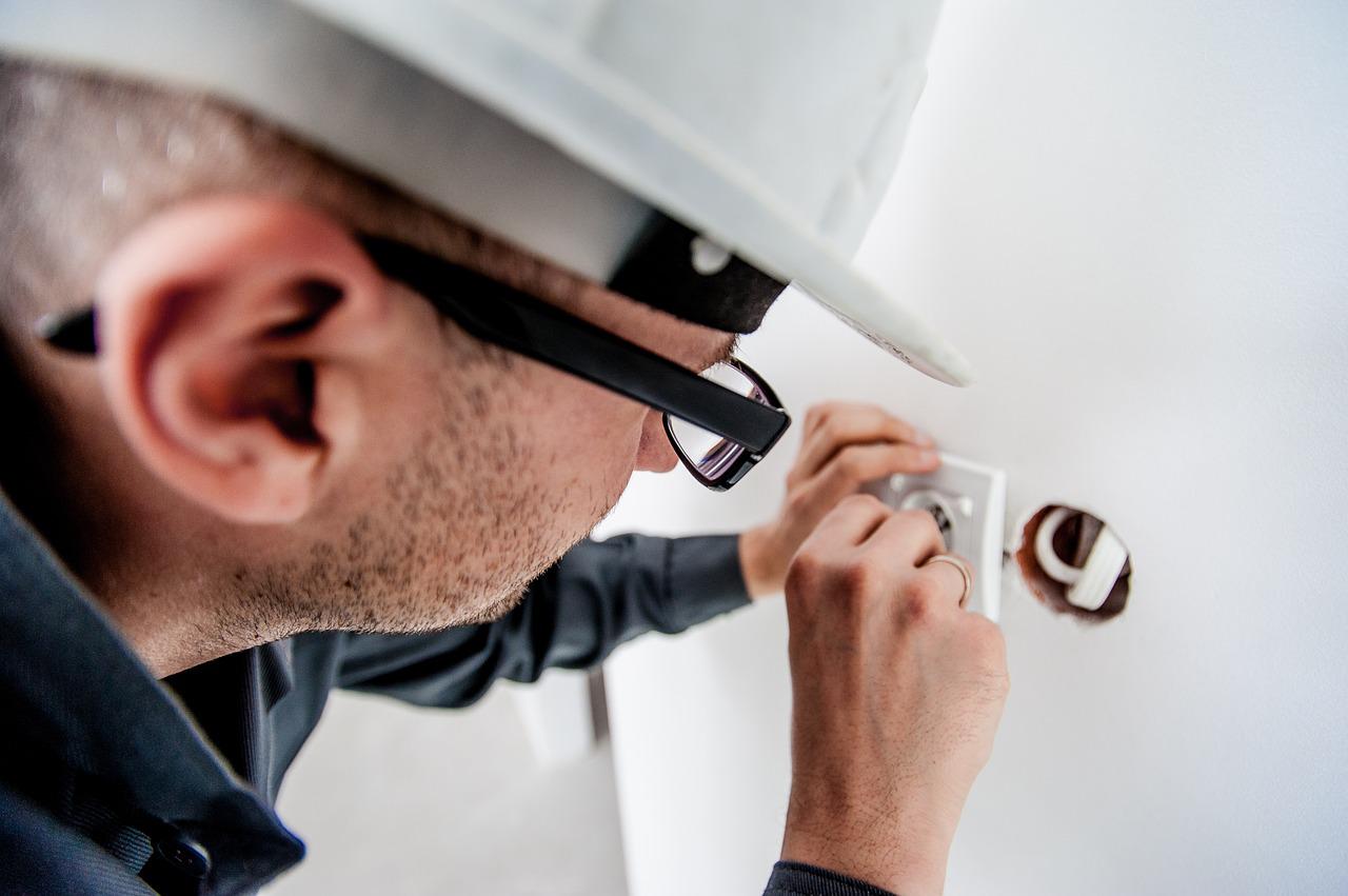 electrician servicing an electrical switch