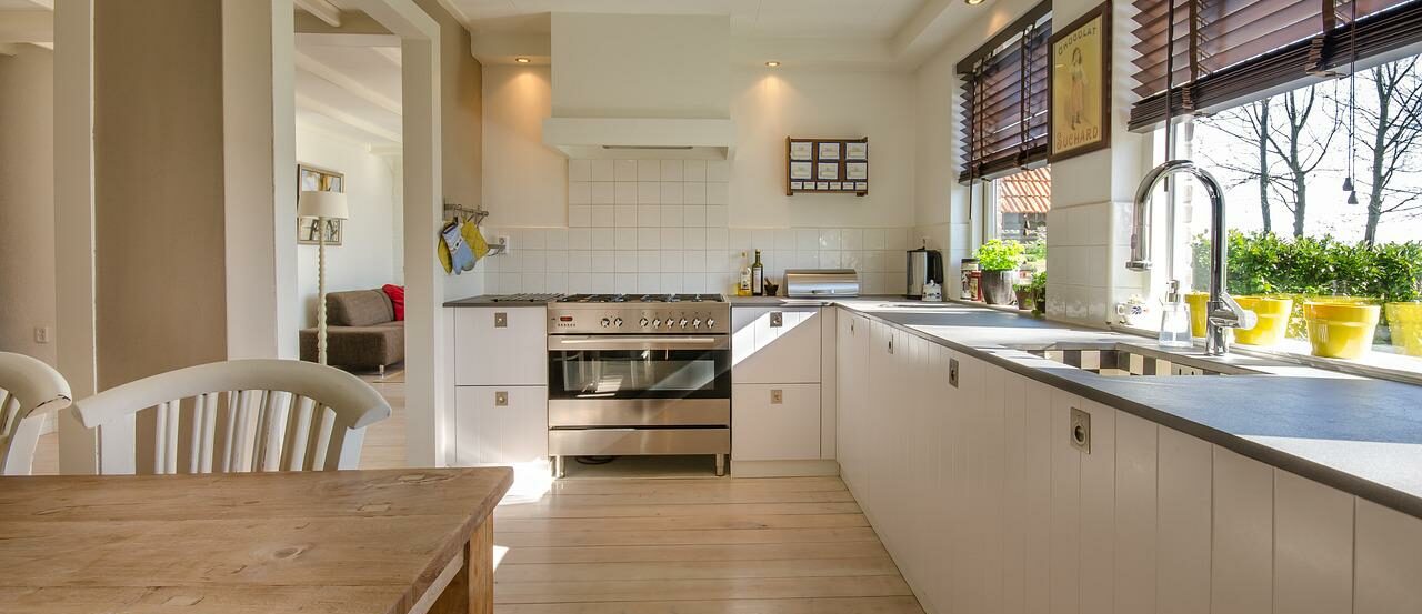 large open kitchen with white cabinets and tiles