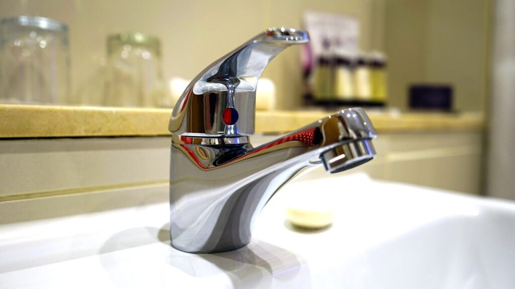 new hot and cold silver faucet with blue and red logo