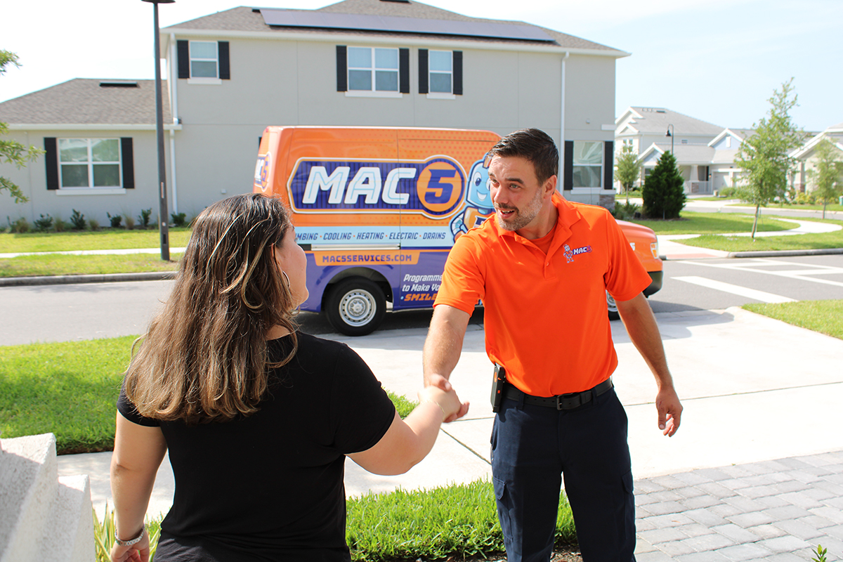Mac 5 service technician shaking hands with homeowner outside