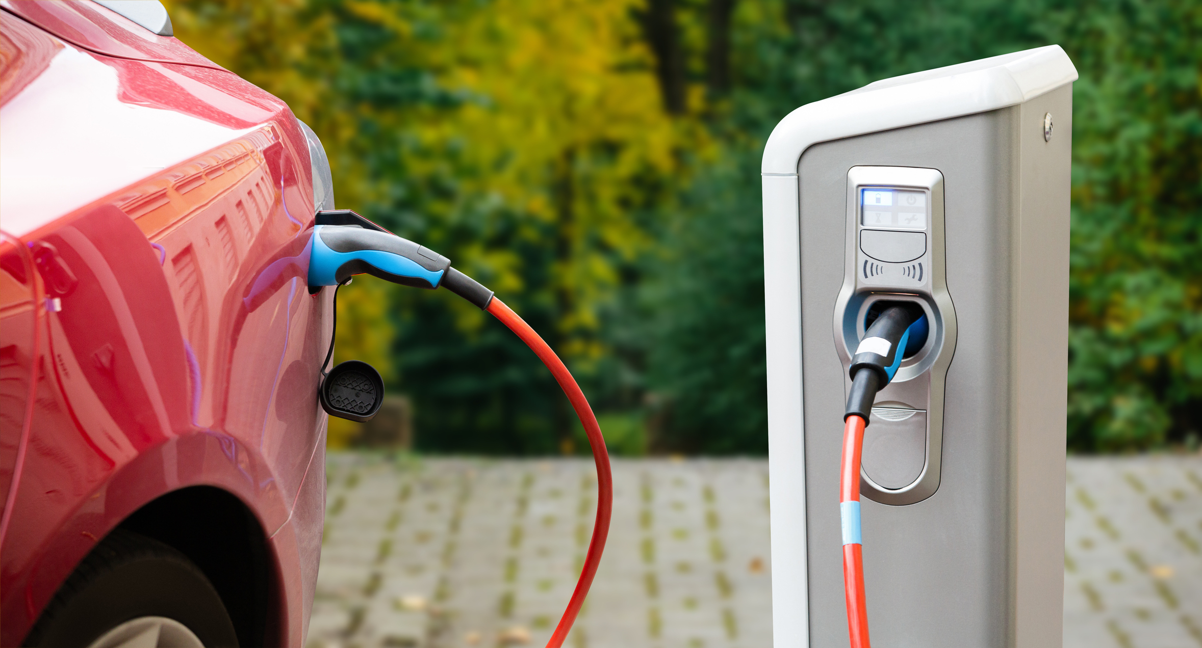 Close-up of a charging red electric car