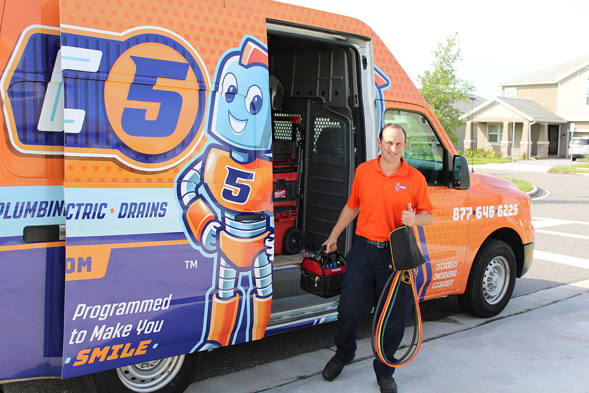 Mac 5 Services technician standing by a mac 5 Service van preparing for sewer line service