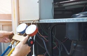 technician servicing an air conditioning unit