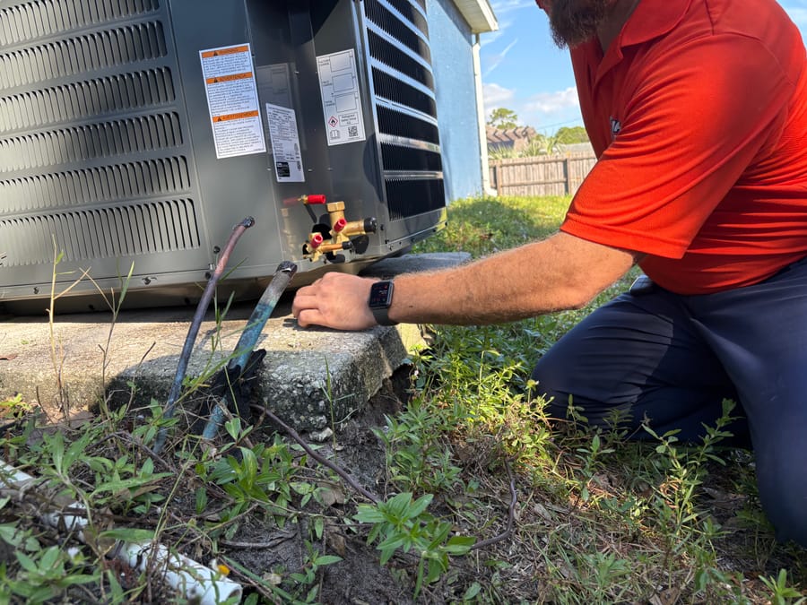 Mac 5 HVAC tech repairing air conditioner.
