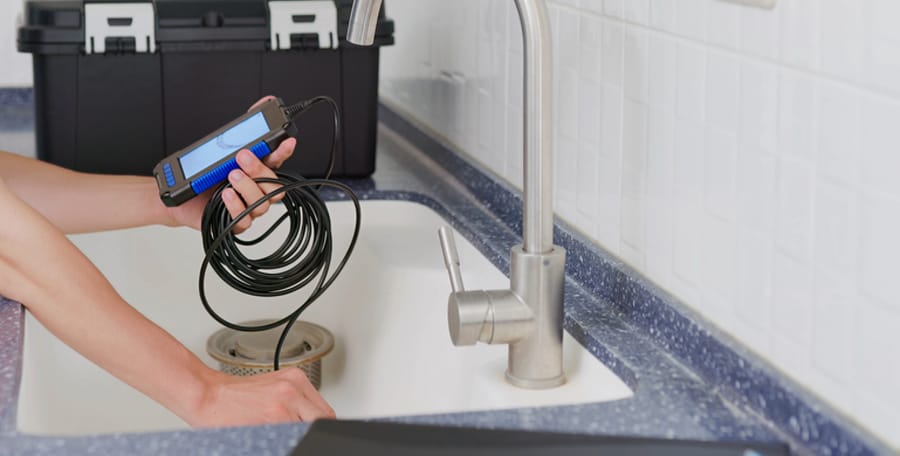 plumber using video camera to inspect drains and pipes.