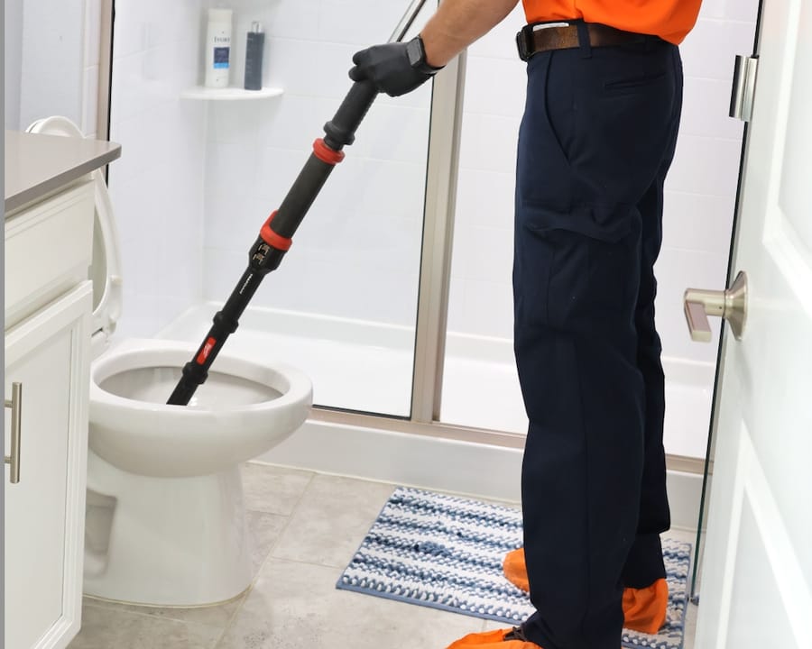 Mac 5 plumber unclogging a clogged toilet.