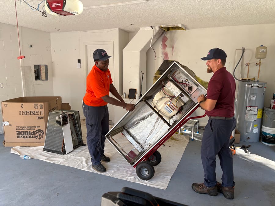 Mac 5 HVAC techs moving an air handler.